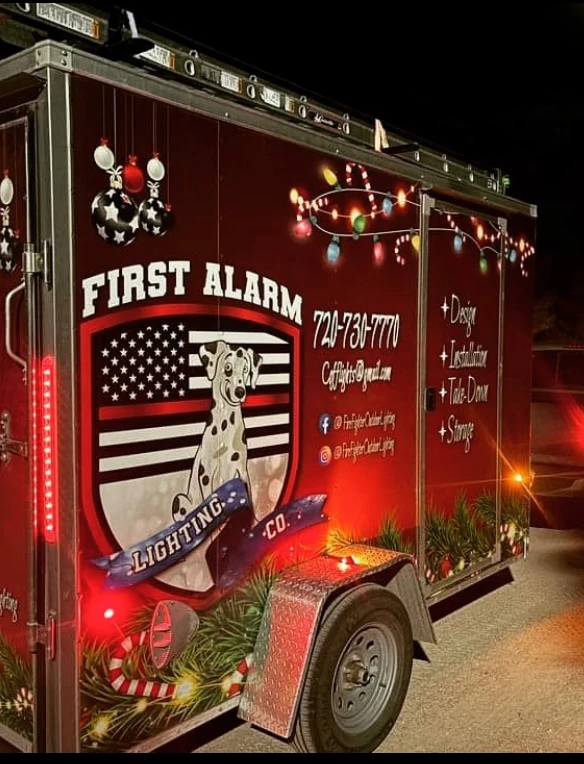 The First Alarm Lighting Co trailer at night, lit and loaded for an install